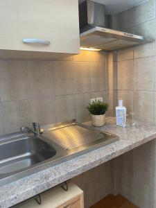a kitchen with a sink and a counter top at Hostal Villa Senese in Paguera