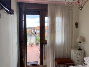 a bedroom with a sliding glass door to a balcony at Posada de Seña in Seña