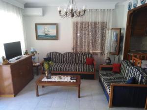 a living room with a couch and a table at Villa elli 2 in Ammouliani