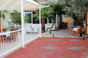 a couple of cats standing on a brick patio at Patara Caretta Hotel in Patara