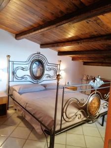 サン・ヴィート・ロ・カーポにあるCasa Marcella San Vito Lo Capoの木製の天井のベッドルーム1室(金属製ベッド1台付)