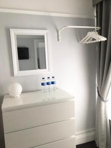 two bottles of water sitting on a dresser in a bathroom at Chadberry House Hotel in Blackpool