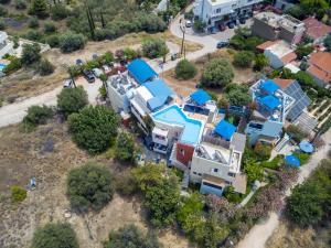 an aerial view of a house with blue roofs at Heliotopos Apartments in Tolo