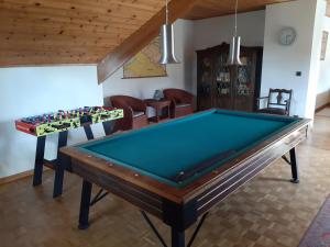 a living room with a pool table and chairs at Den Donkman in Dessel