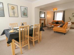 a dining room with a table and chairs and a living room at Nappers Cottage in Hayle