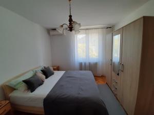 a bedroom with a large bed and a window at Apartment Adriatic Sea View Zoe in Rovinj
