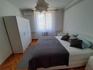 a bedroom with a large bed with pillows on it at Apartment Adriatic Sea View Zoe in Rovinj