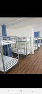 a row of bunk beds in a room at Albergue Turístico La Peregrina in Oviedo