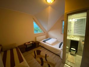 a small bedroom with a bed and a bathroom at Vila Eszter in Sovata +26 photos