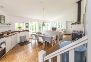 a kitchen and living room with a table and chairs at Little Winters Cottage in Lyme Regis