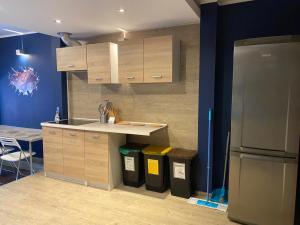 a kitchen with a counter and a refrigerator at Hostel Galaxy in Gdańsk