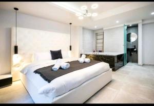 a bedroom with a large bed and a bath room at Romantic Jacuzzi Apartment in Athens