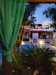 a view of a house and a swimming pool at night at Villa Stella D'oro in Georgioupolis