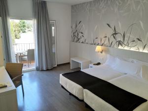 Posteľ alebo postele v izbe v ubytovaní Hotel Mediterrani