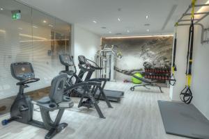 a gym with several treadmills and exercise bikes at Hotel Juliani - Boutique Hotel in St. Julianʼs