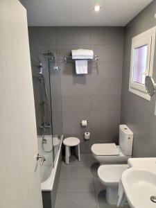 a bathroom with a shower and a toilet and a sink at Hotel Mediterrani in Calella de Palafrugell
