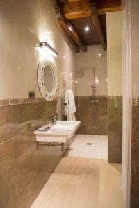 a bathroom with a sink and a shower at Osabarena Hotela in Murueta-Orozko