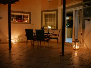 a dining room with a table and chairs and lights at D&K Studio in Myrina