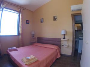 Un pat sau paturi într-o cameră la Appartamento In Villa Di Judighes