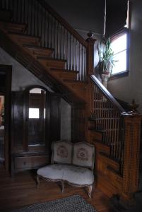 a wooden staircase leading up to a balcony at Off Broadway B & B in Denver