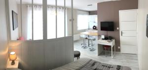 a bedroom with a bed and a desk with a computer at Charmant Studio 25 m2, 900m de la plage in Les Sables-d'Olonne