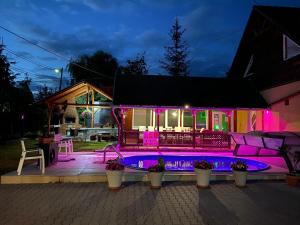 a house with a swimming pool at night at Vila Eszter in Sovata