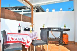 a patio with a table with a bottle of wine at Apartamento Veronica H in Málaga