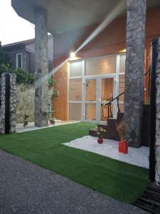 a house with a green lawn in front of it at Casa B&D Residence in Deva