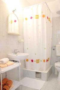 a bathroom with a shower curtain and a sink at Apartments Marin in Bol