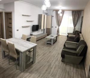 a living room with a table and a couch at Ideal MoonLight Residence in Mamaia
