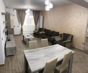 a living room with a table and a couch at Ideal MoonLight Residence in Mamaia