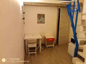 a small room with a table and a staircase at Bed & Breakfast Le Torri in Otranto