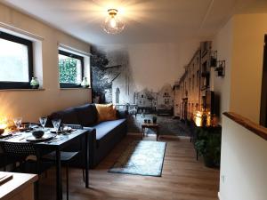 a living room with a couch and a table at Studio Belga Begijnhof Tongeren in Tongeren