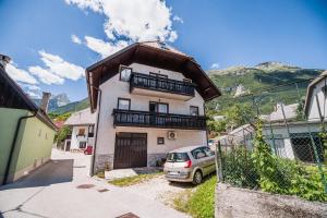 a house with a car parked in front of it at Vila K29 in Bovec