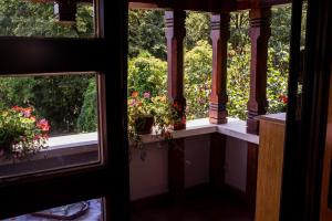 a room with two windows with flowers in them at Rapsodia Pension in Suceava