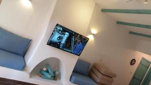 a living room with a tv on the wall at La Hacienda - Ras Sedr Chalet - Ras Sudr in Ras Sedr