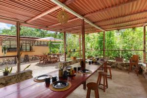 an outdoor dining area with a wooden table and chairs at MELI-MELO P&B in Tulum