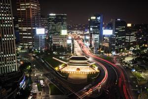 a city at night with traffic on a freeway at Fraser Place Namdaemun in Seoul