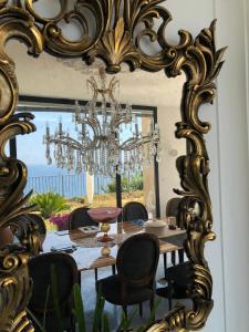 a dining room table with a mirror and chairs in front of it at La Casa Di Sissi B&B in Sanremo
