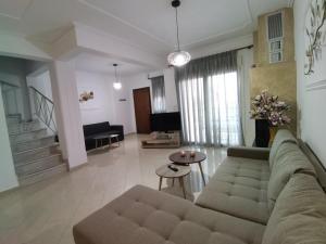 a living room with a couch and a table at Evris House 1 in Kavala