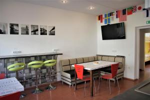 a living room filled with furniture and a tv at Central Hostel Jelgava in Jelgava