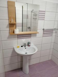 a bathroom with a white sink and a mirror at Didy Residence in Eforie Nord +21 photos