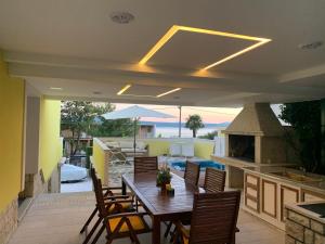 a patio with a table and chairs and a stove at Apartments & Rooms Marina in Dramalj