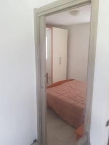- une chambre avec un lit et une porte menant à une pièce dans l'établissement La Grolla, à Aoste