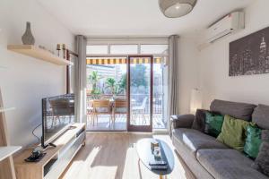 a living room with a couch and a table at Appartement TANIA HIND MAYA in Salou