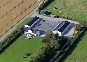 an aerial view of a house in a field at Vestbjerg Apartments in Vestbjerg