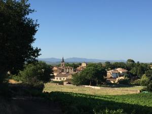 a view of a small village with a church at Plein Sud : jolie maison dans village pittoresque de l'Hérault. in Nizas +1 photo