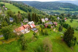 an aerial view of a small village in a green field at Apartmány Nad Šlikovkou in Jáchymov