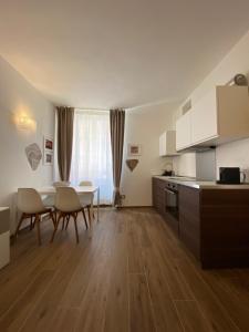 a kitchen and dining room with a table and chairs at Carruggio 151-2 in Sestri Levante +9 photos