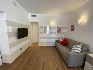 a living room with a couch and a flat screen tv at Carruggio 151-2 in Sestri Levante